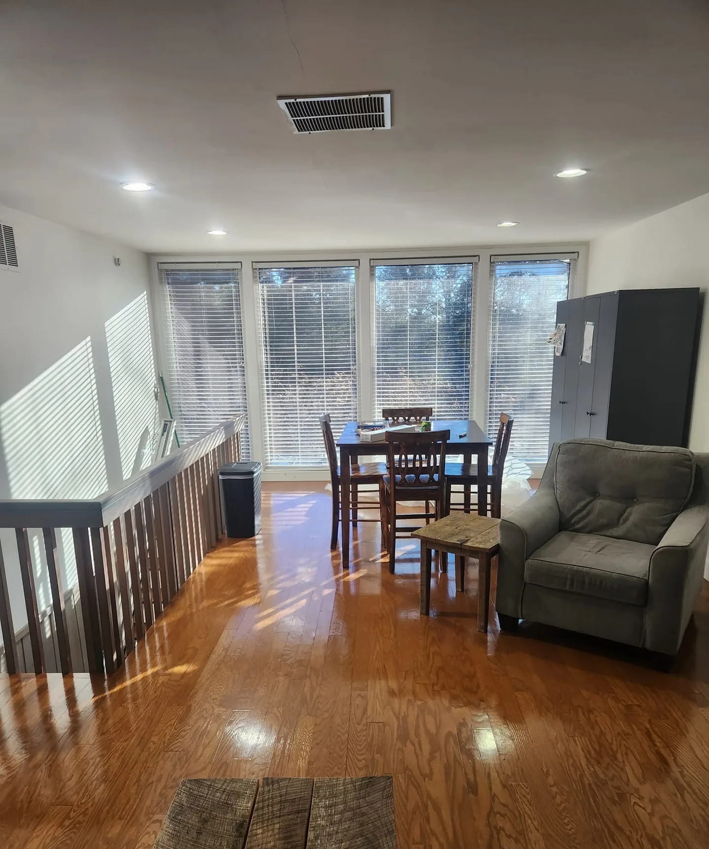 Finished room with new hardwood floors, railing and dining area
