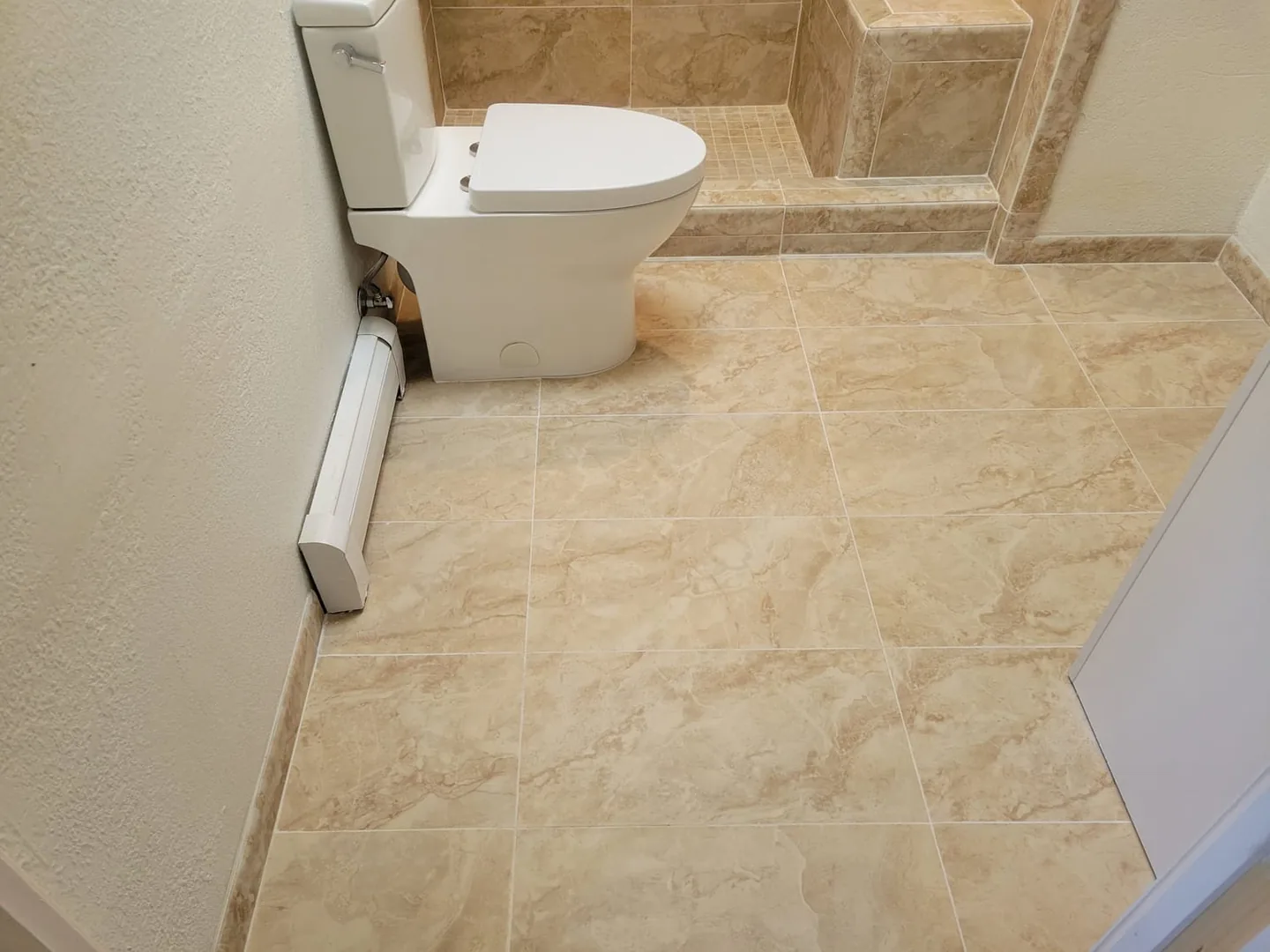 New marble-look tile floor in a remodeled bathroom
