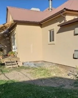 Backyard before: bare lawn beside the house